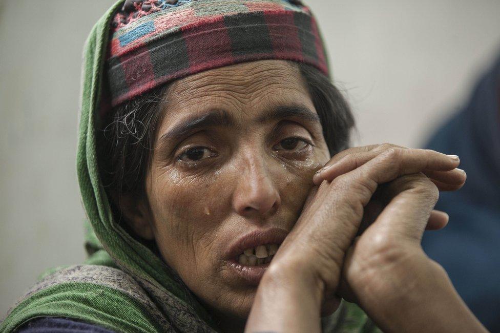 A woman at the relief camp is seen crying.