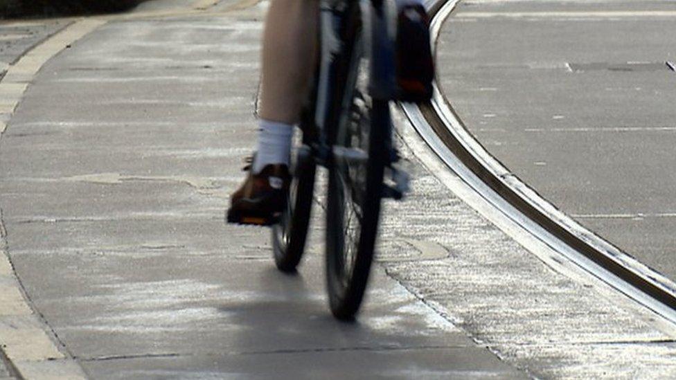 Cyclist alongside tram tracks