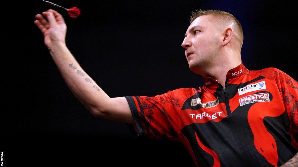 Nathan Aspinall throws a dart