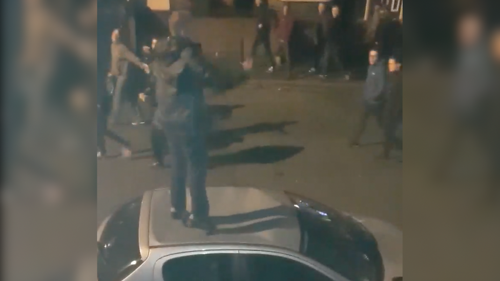 Football fan jumping on car