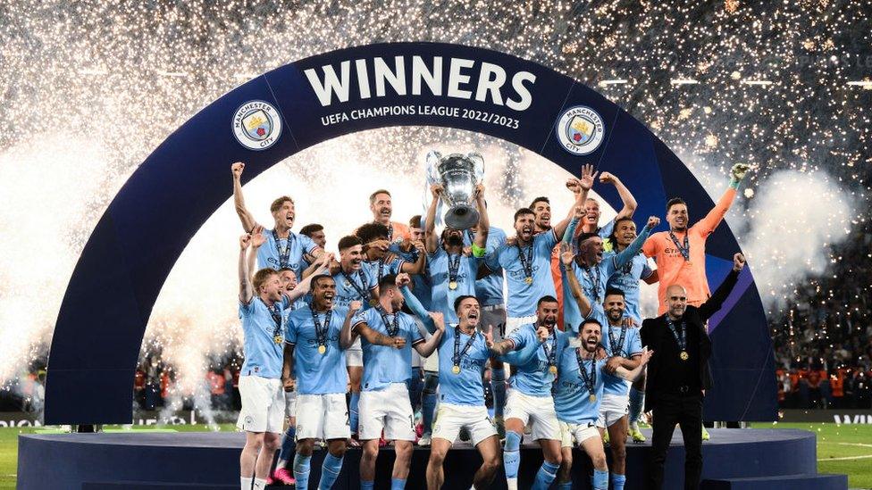 Manchester City lifting Champions League trophy