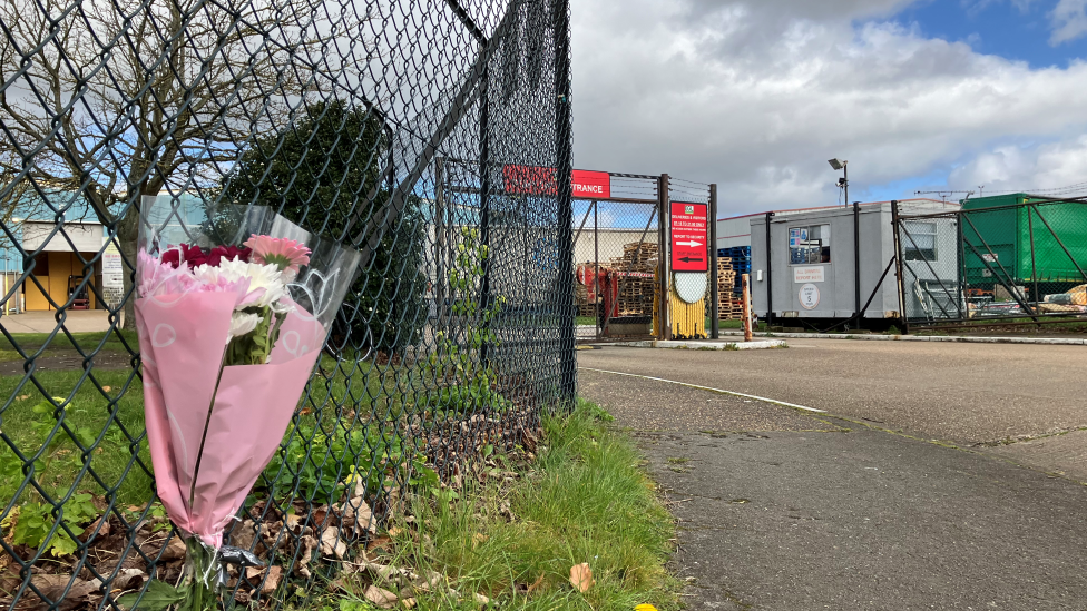 A bouquet of flowers outside an industrial site