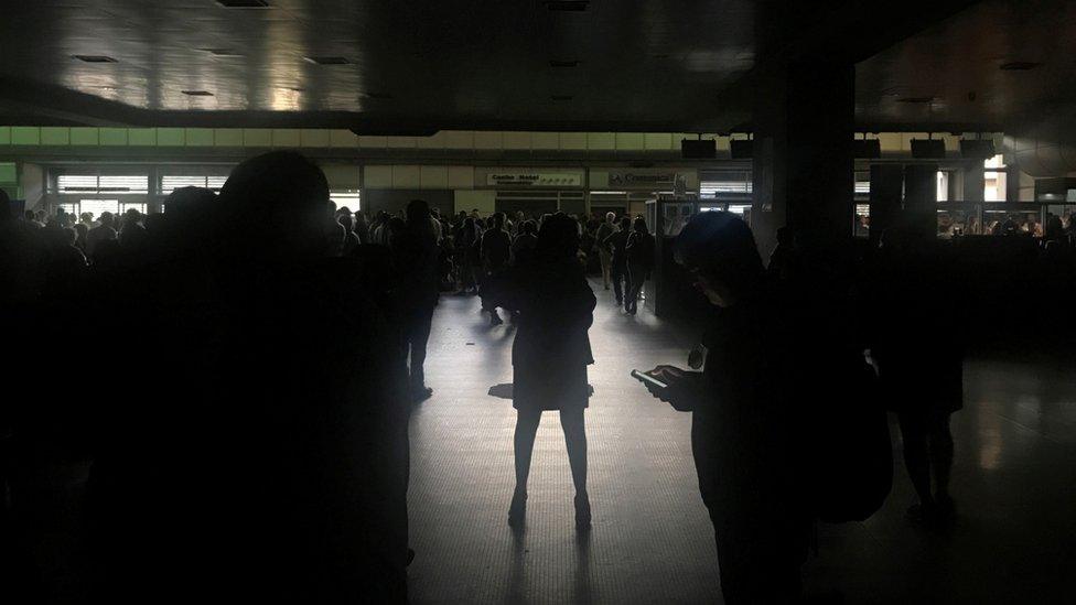 Passengers are seen during a blackout at Simon Bolivar international airport in Caracas, Venezuela March 25, 20