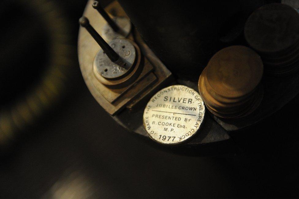 Old fashioned pennies on the pendulum of the Clock accurate