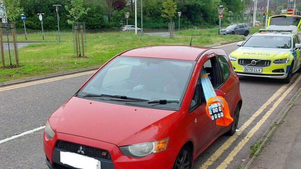 Car with wood sticking out of window