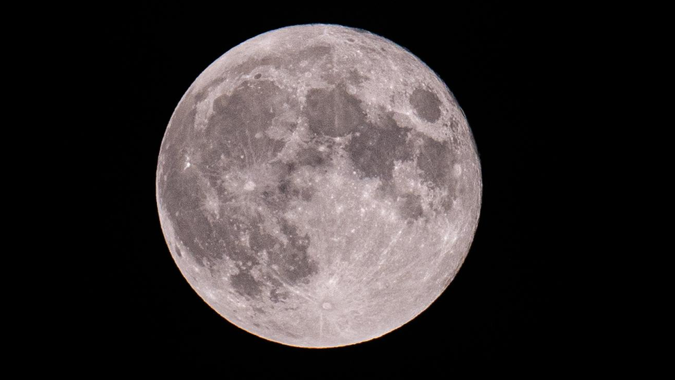 The full Moon in a dark sky