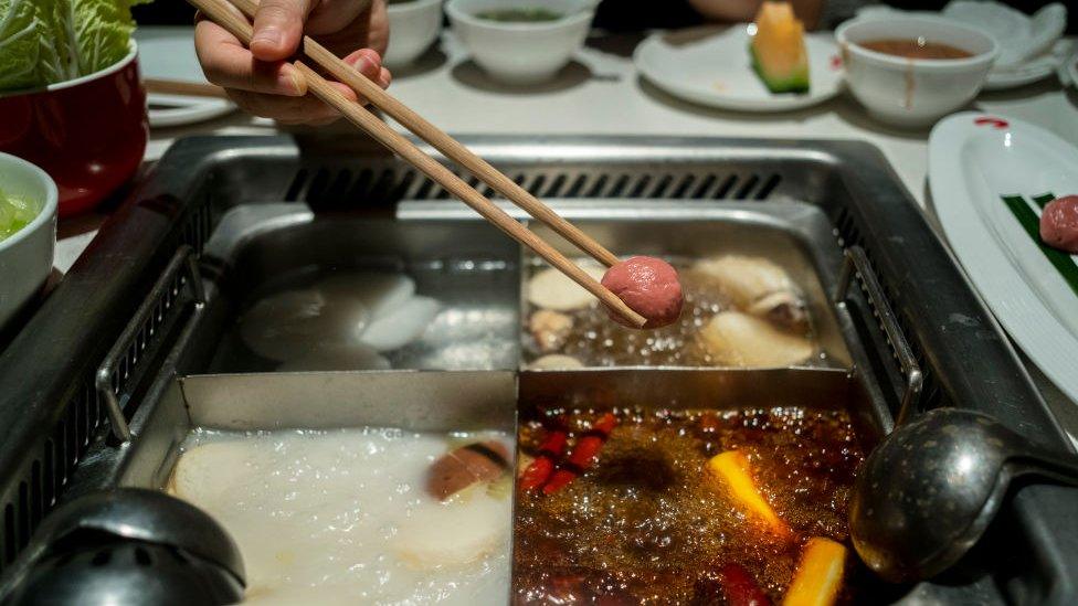 Customers eat hotpot in a Haidilao restaurant