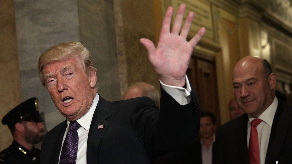 U.S. President Donald Trump (L) waves as he arrives at the Capitol with Director of the National Economic Council Gary Cohn (R) for a House Republican Conference meeting November 16, 2017 in Washington, DC.