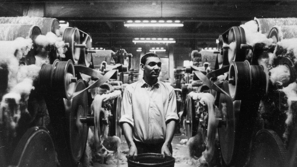 An immigrant employee from Pakistan at work in a spinning mill in Bradford, West Yorkshire