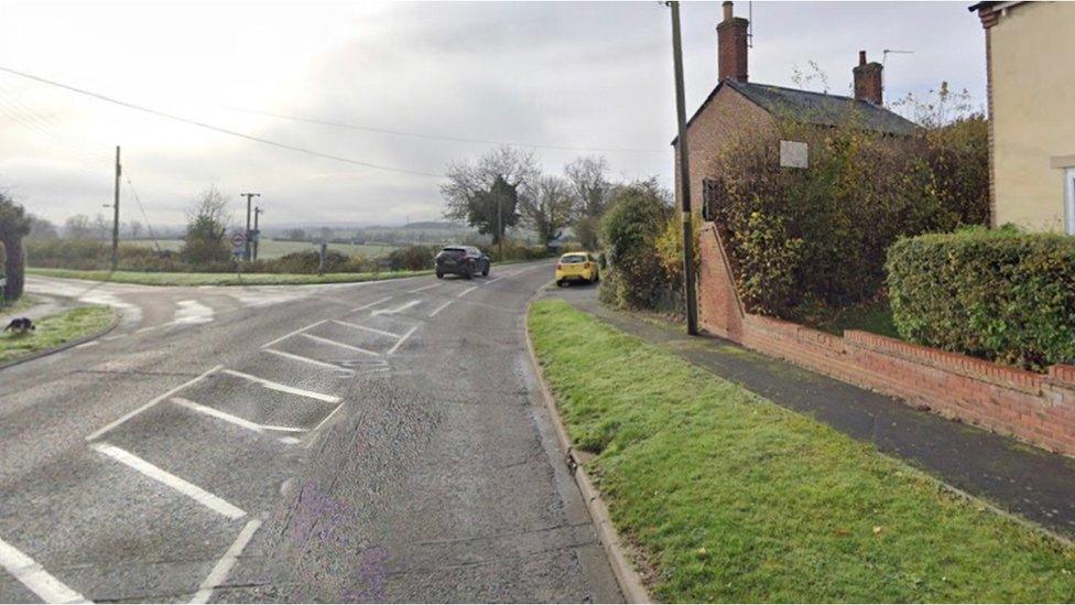 Sweeping bend in the road on the edge of a village.