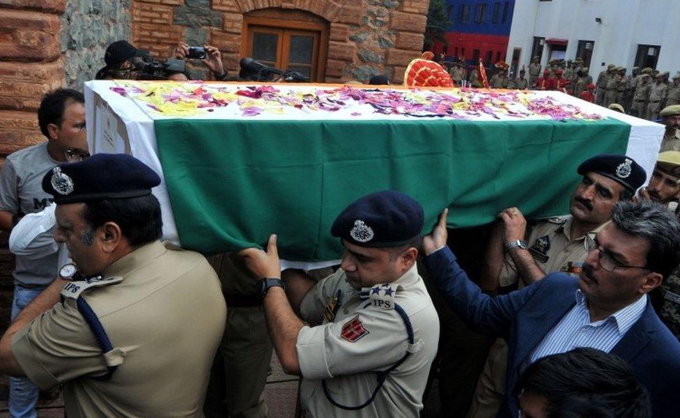 Indian police officers carry a coffin with the body of a slain colleague Parvaiz Ahmed in Srinagar on 12 August 2018.