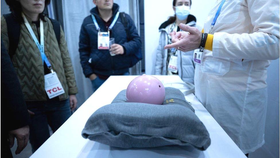 A bowling ball sitting on the AI pillow