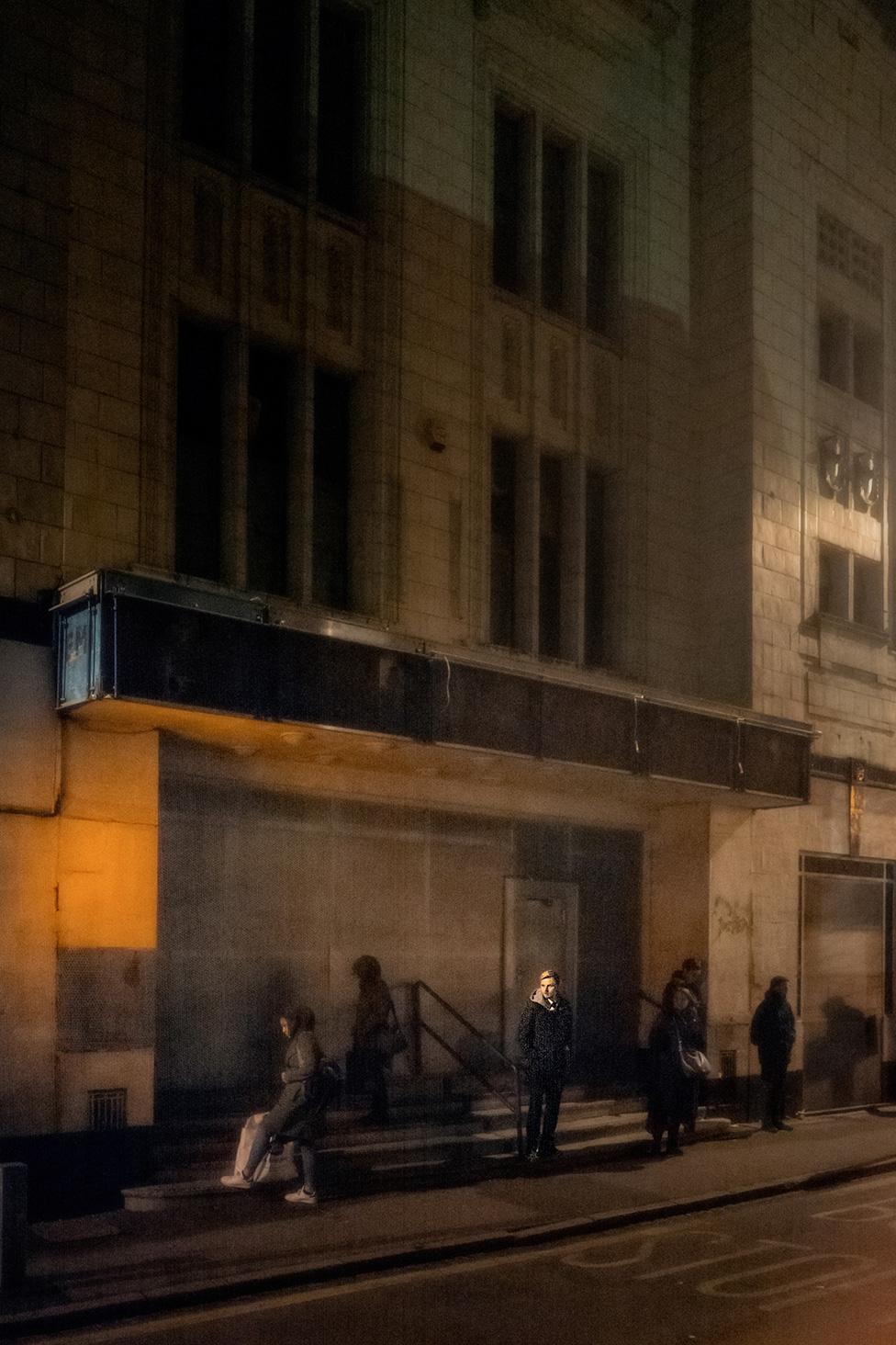 People outside an empty cinema