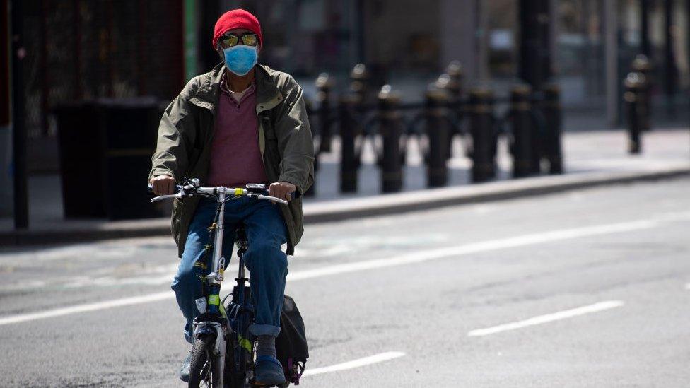 Man with face covering on mask