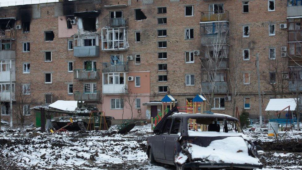 Destroyed apartment block and car in the pro-Russian separatists-controlled Donetsk, Ukraine on 11 March 11