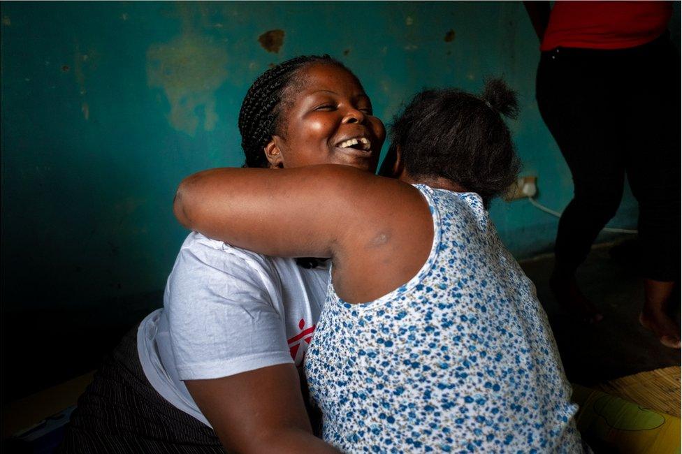 A woman hugging another woman