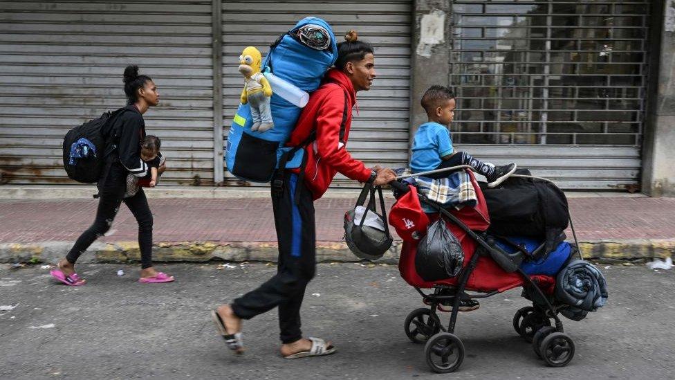 A Venezuelan family heads to the Temporary Housing Center for Migrants San Antonio Casa Esperanza after walking for weeks in order to cross into Colombia and continue their journey to the United States, in San Antonio del Tachira, Venezuela, on September 25, 2022.