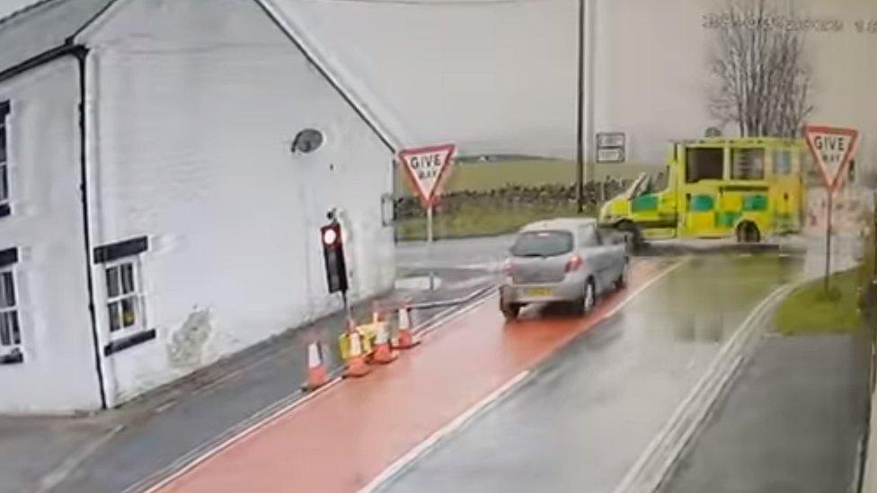 Car narrowly avoids ambulance at crossroads