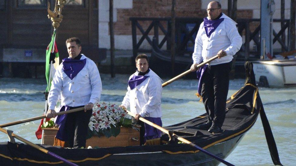 The coffin containing the body of Valeria Solesin, an Italian victim of last week's Paris attacks, is carried by gondoliers