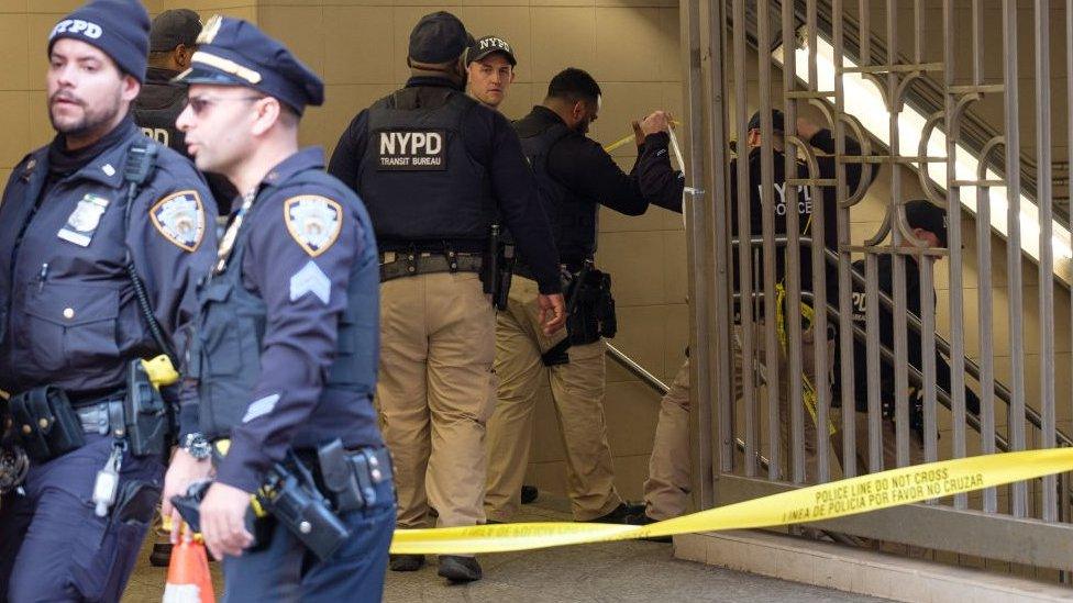 Police tape and officers block entrance to the station