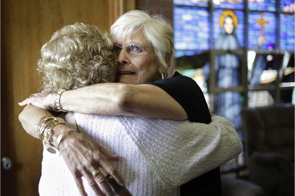 Nancy Shilts hugs another parishioner before the final service