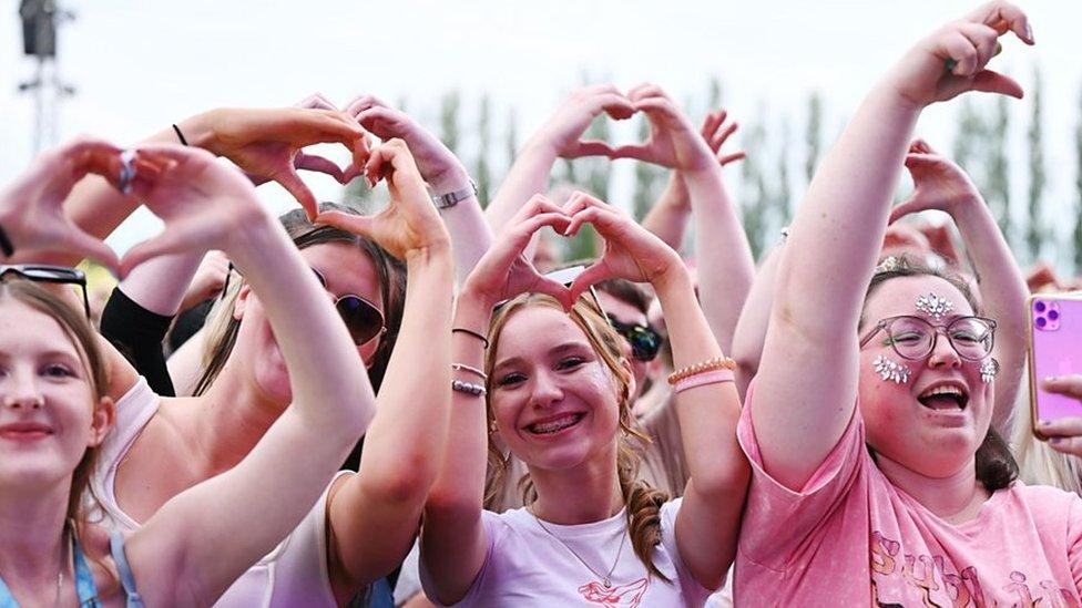 Fans make heart signs at Radio 1's Big Weekend.