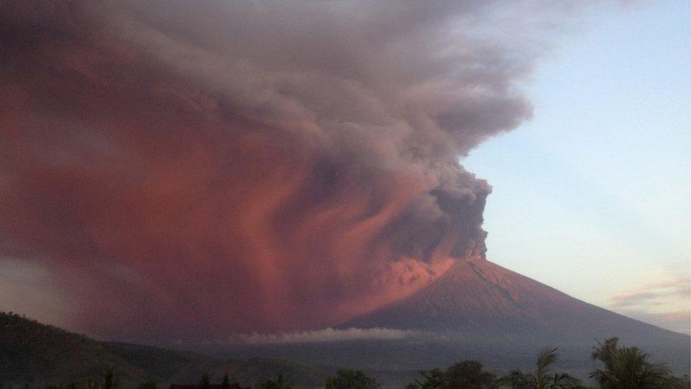 Indonesia"s Mount Agung volcano erupts as seen from Amed, Karangasem, Bali at sunrise