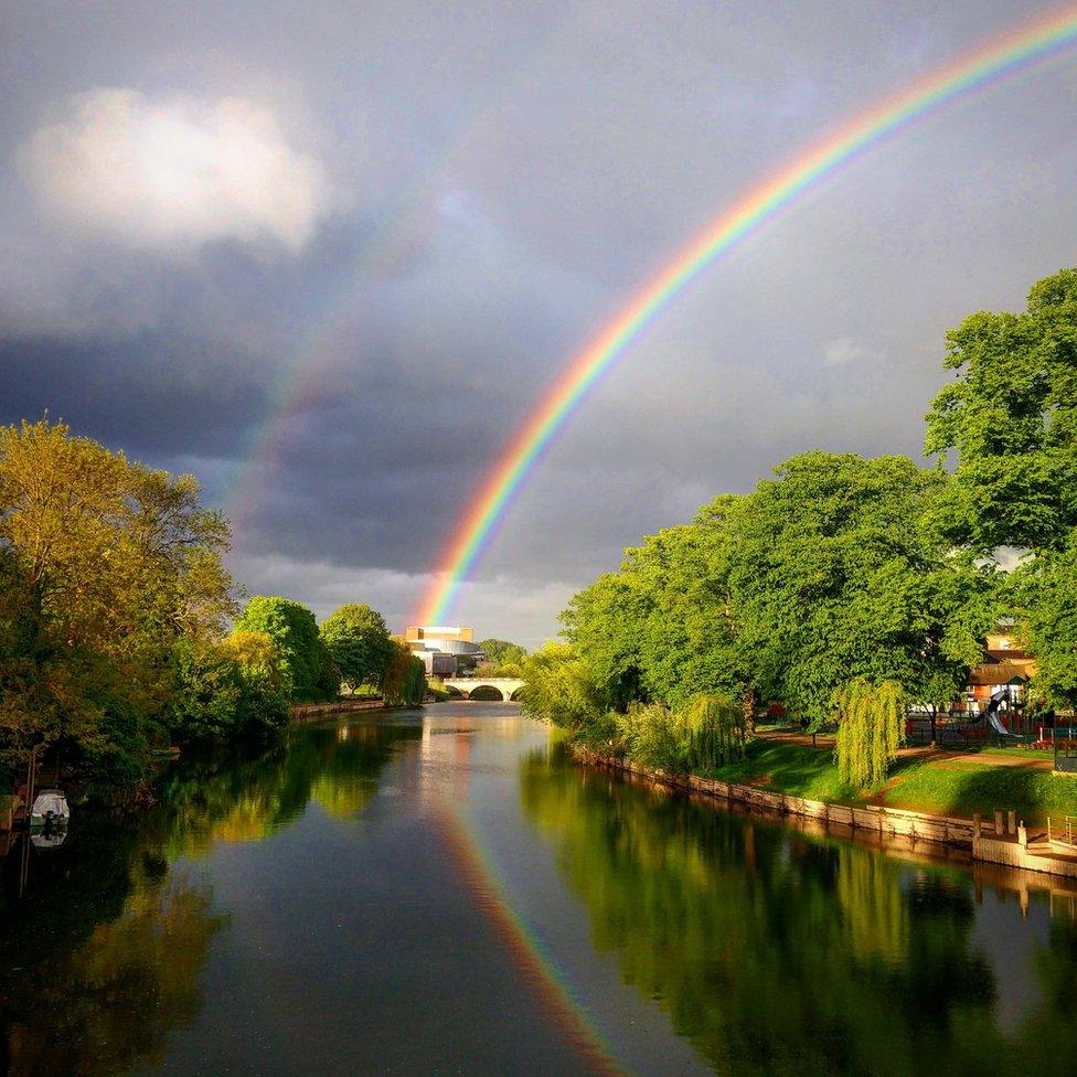 A double rainbow reflected in water