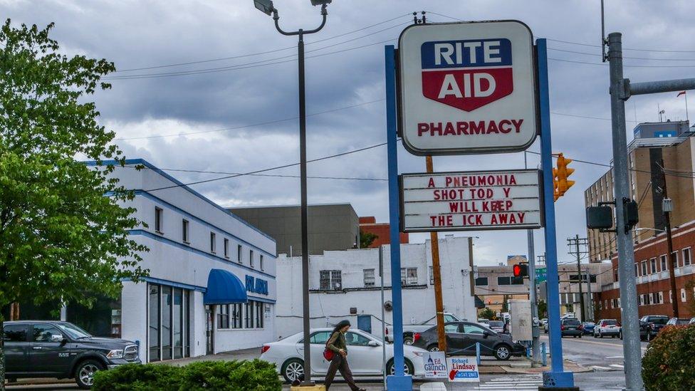 Pharmacy in Charleston with sign: A pneumonia shot today will keep the ick away