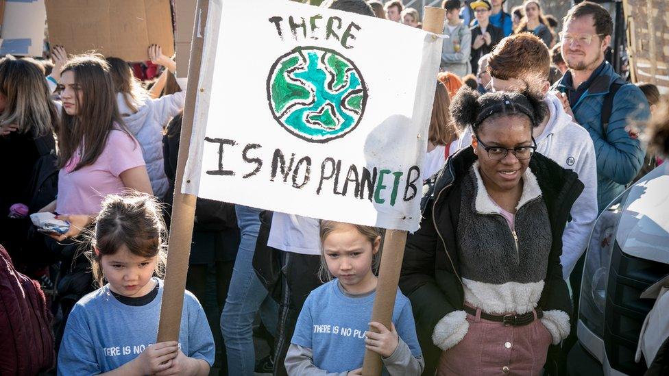 Kids protest with a banner saying there is no planet b