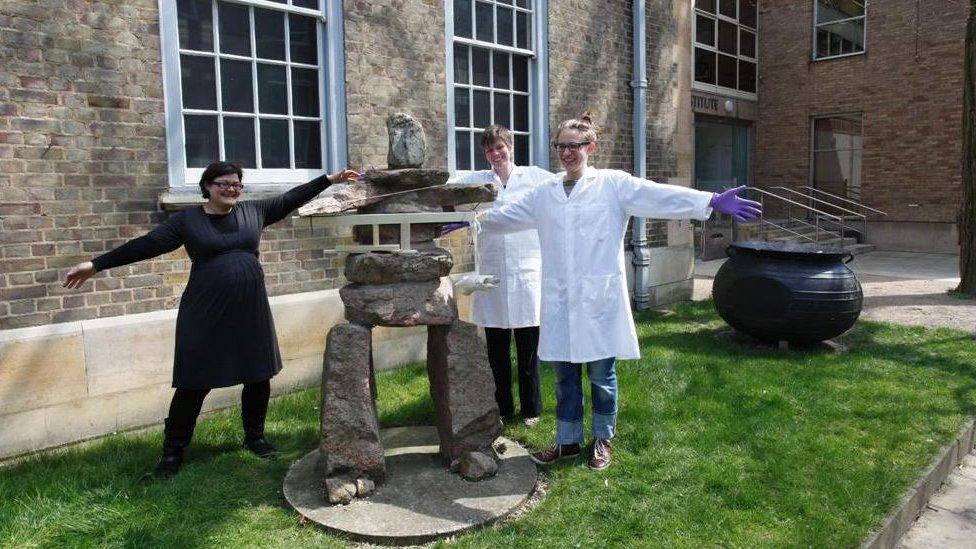 Staff restoring inukshuk in 2013