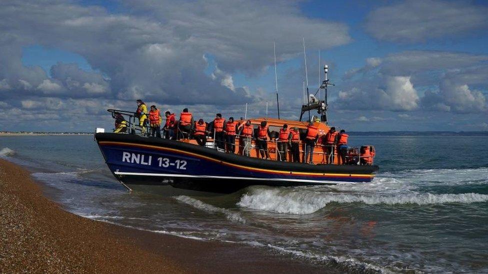 A group of people thought to be migrants are brought in to Dungeness, Kent, by the RNLI