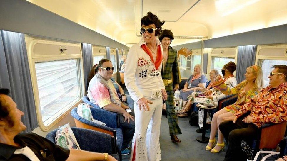 Elvis fans travel on a train after leaving Central station to head to The Parkes Elvis Festival, in Sydney on January 10, 2019