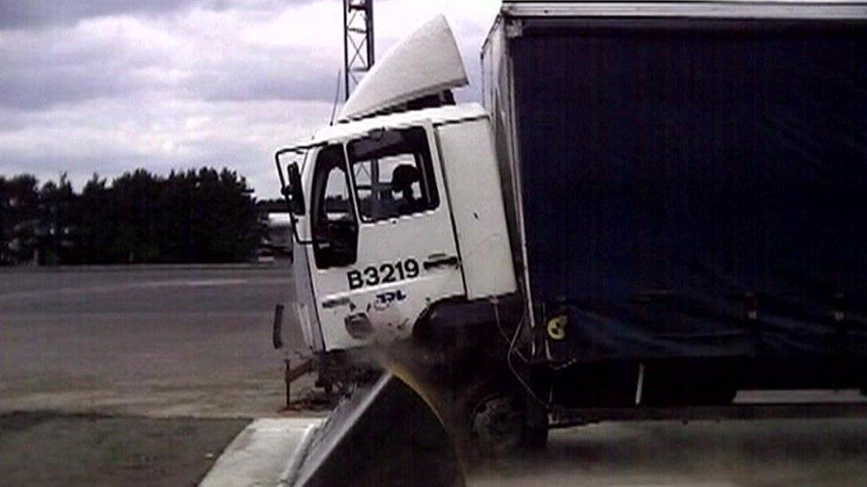 A truck smashing into a truck barrier ramp