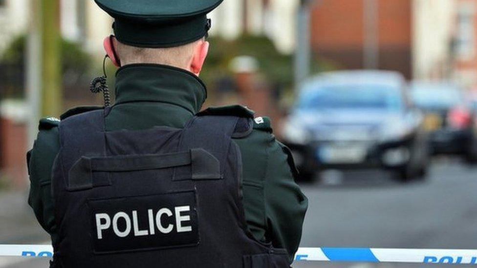 A police officer standing at a cordon