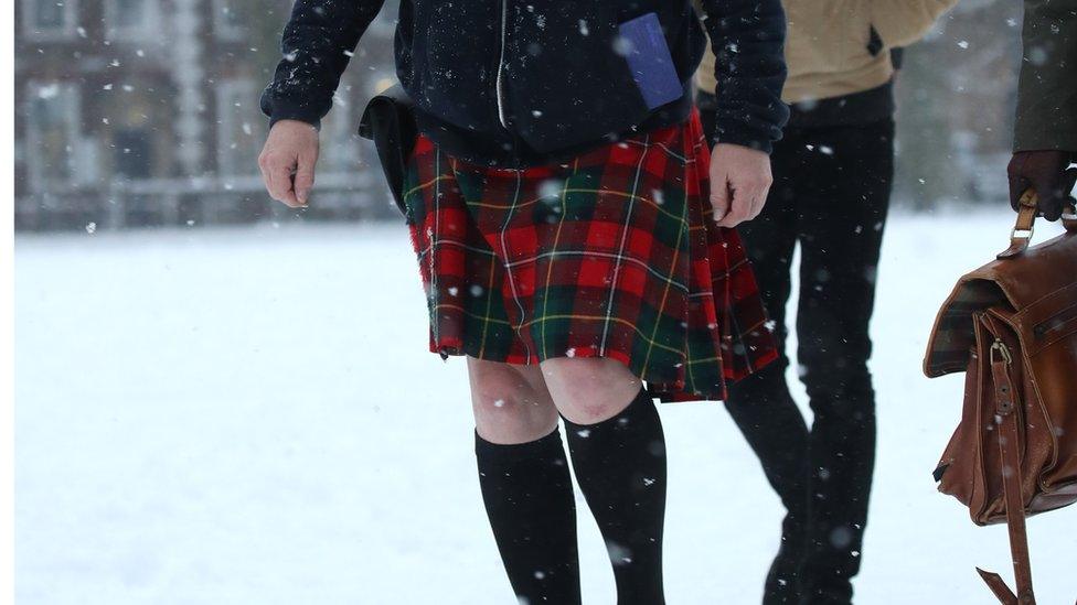 A commuter in a kilt in the snow.