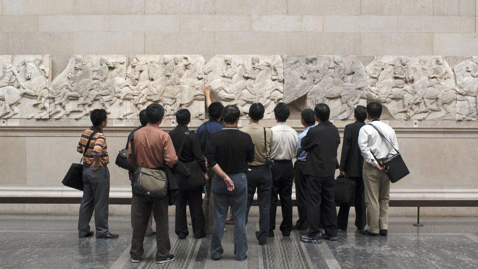 People viewing the Elgin Marbles on display at the British Museum