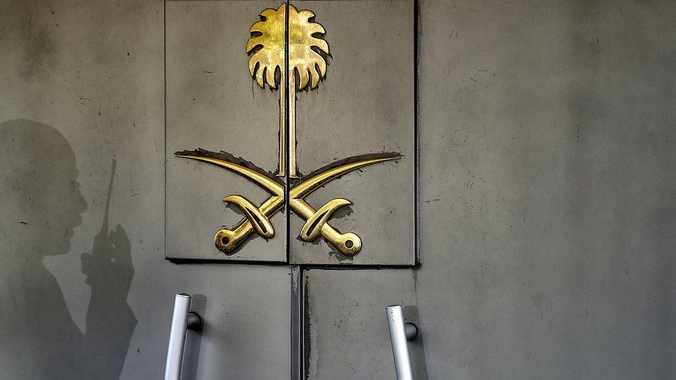 The shadow of a security member of the consulate is seen on the door of the Saudi Arabian consulate on 1 November 2018 in Istanbul