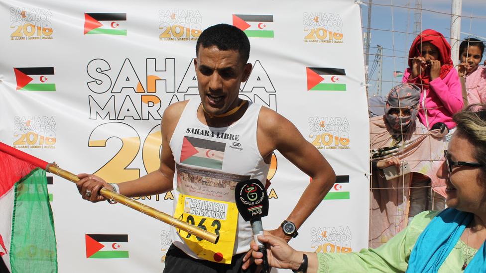 Salah Ameidan holding the Saharawi flag