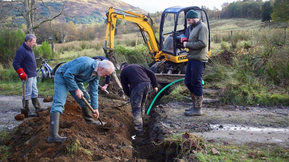 Residents laying the cables