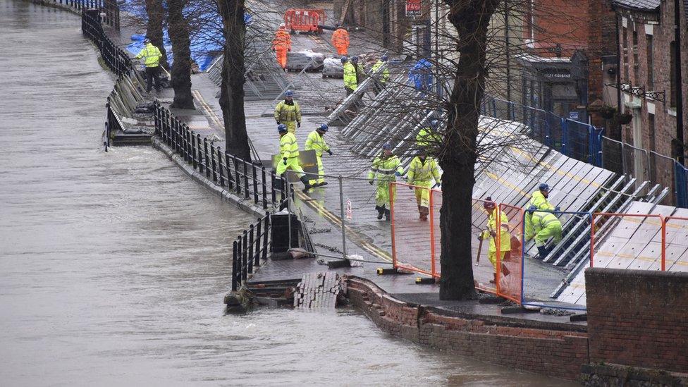 Environment Agency teams work on temporary flood barriers in the Wharfage area of Ironbridge, Shropshire, after floodwaters receded following an emergency evacuation of some properties earlier this week.