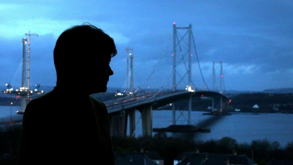 First Minister Nicola Sturgeon looks out from a window over at the Forth Road Bridge as she speaks to the media at Traffic Scotland Control Centre at South Queensferry