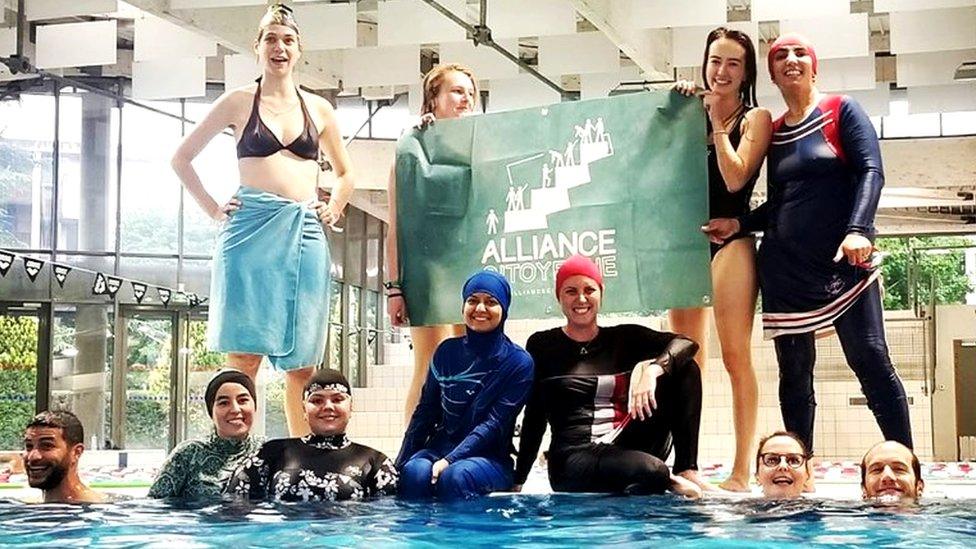 Members of the campaign group Citizen Alliance of Grenoble protest at a community pool in Grenoble, France