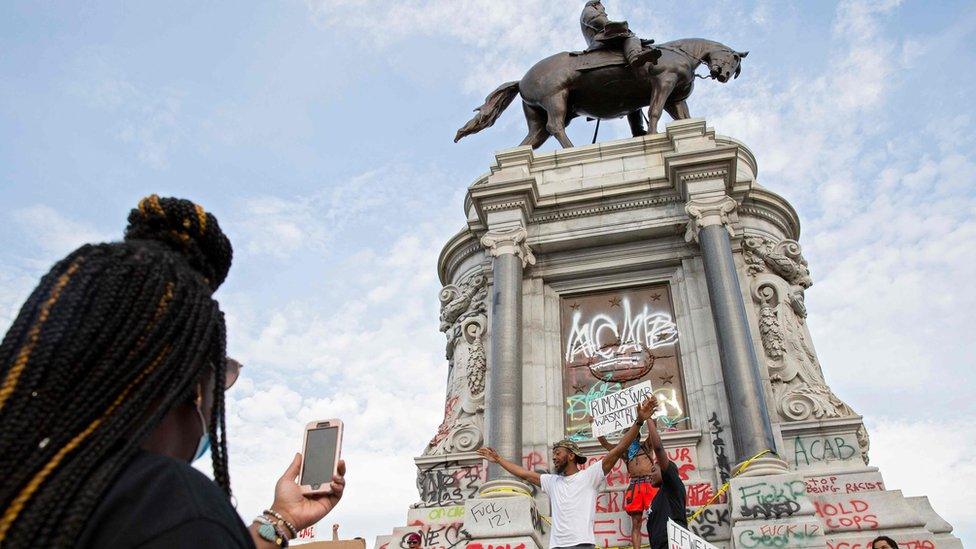 People gather around the Robert E Lee statue on Monument Avenue in Richmond, Virginia, on 4 June, 2020