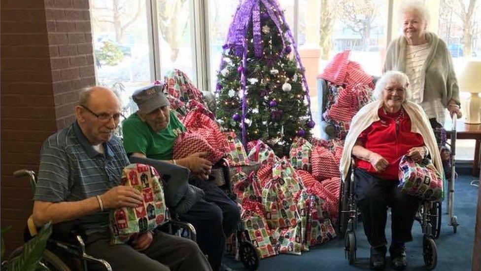 Residents at The Pines nursing home in Glen Falls receive their Christmas gift bags