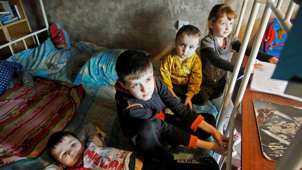 The Shevchenko children play in a hostel room after being evacuated from their home in a Donetsk suburb afte5r shelling, 2 February