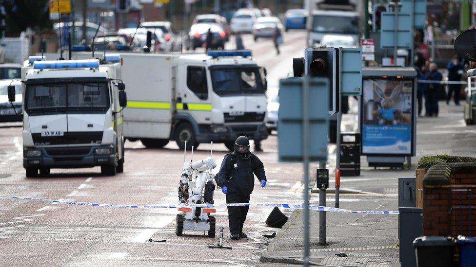 A bomb disposal officer at the scene of a car bomb attack on a prison officer in east Belfast