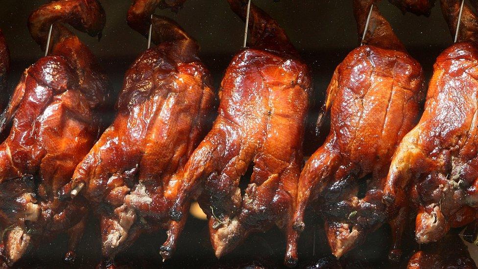 Crispy duck, hanging in the window of a restaurant