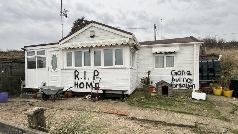 Graffiti has been scrawled on one of the homes due for demolition