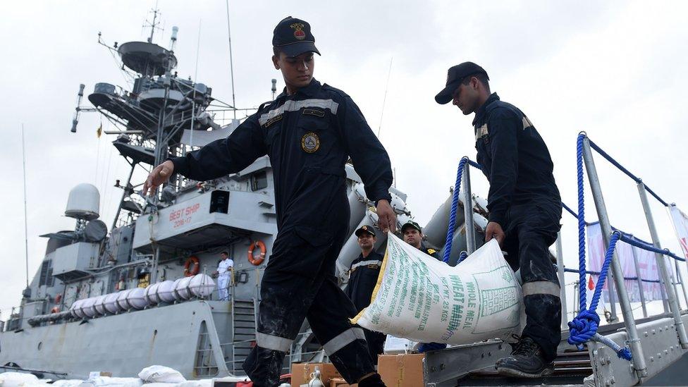 Indian Navy troops offload emergency supplies from the Indian ship Kirch at Colombo harbour.